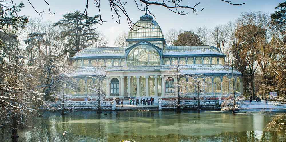 Madrid In Winter: Over 30 Things to Do In Winter in Madrid 3 The Crystal Palace in Parque El Retiro with snow on the building and trees