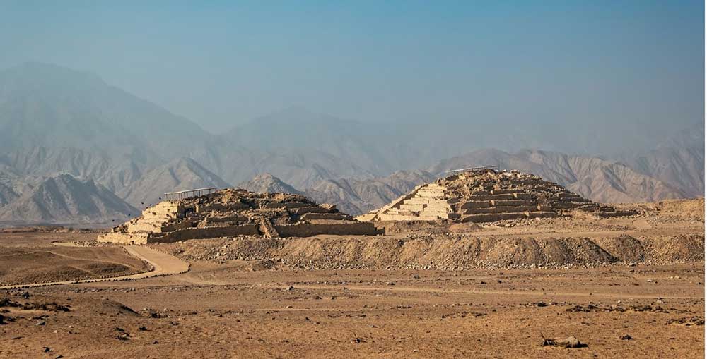 Two ruins of pyramids in the desert at Caral.