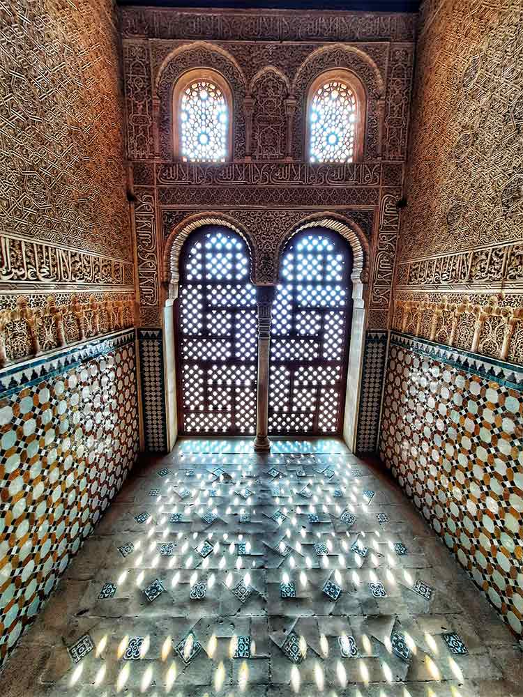 The Alhambra in Granada, Spain, boasts intricate details and mesmerizing mosaic patterns adorning its walls and tiles.