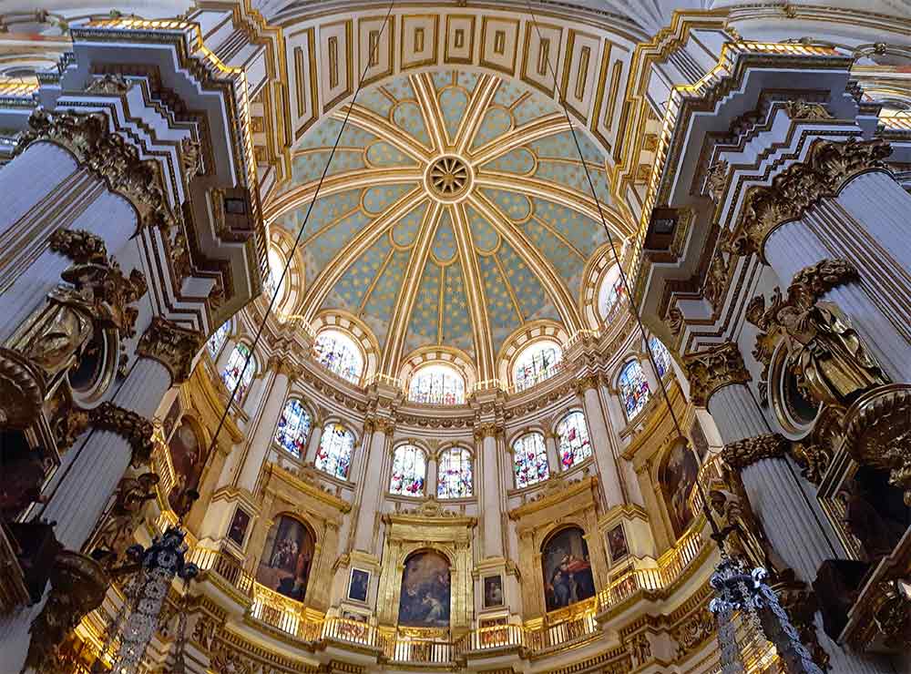 Cathedral of Sagrada featuring its high ceilings with intricated details on the windows and paintings