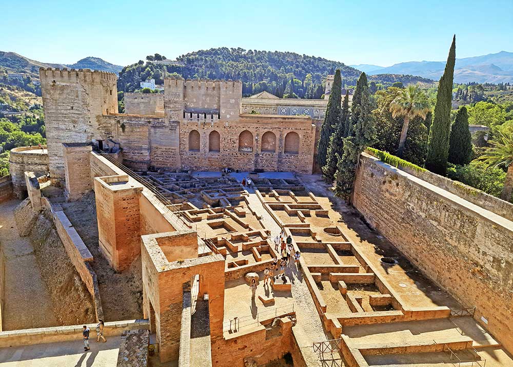 Aerial view of the Alcazaba in Granada featuring a remains of the military fortress - just like a small maze surrounded by a high walls