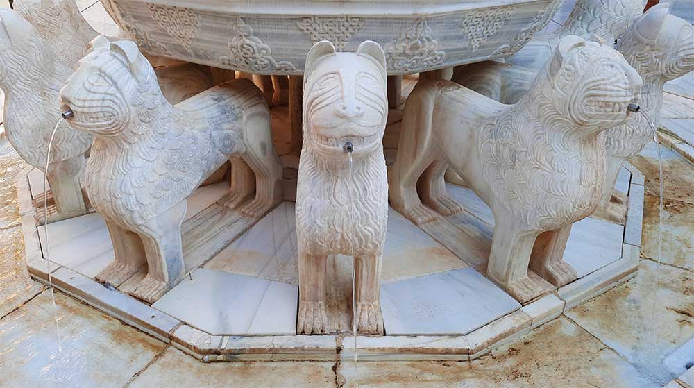 The Lion Fountain at Nasrid Palaces showcases its sculpture lion-look like with intricate carvings on a white marble stone