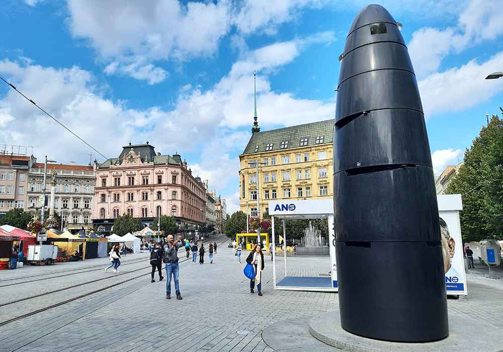 The Brno Astronomical clock in Liberty Square. The clock is in black granite and shaped like a giant bullet. 