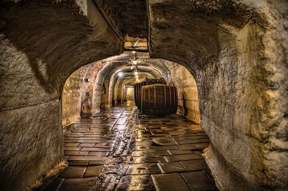 Underground cellars of Pilsner Urquell with large barrels. 