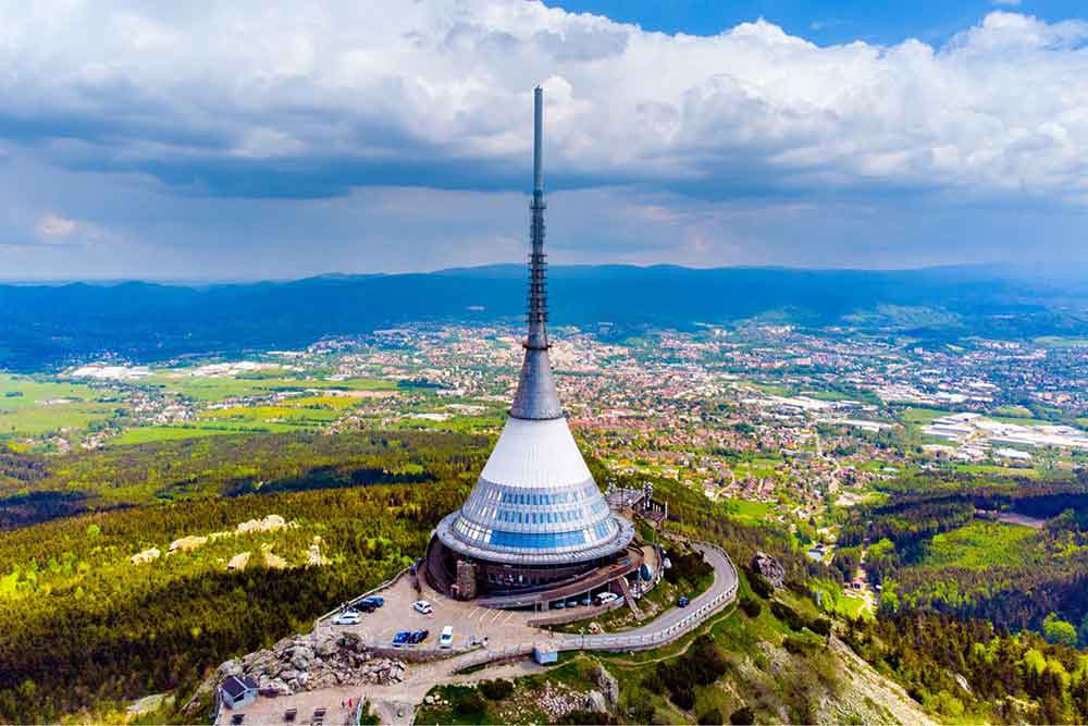 The Jested Tower, shaped like an upside down funnel on top of a hill. 