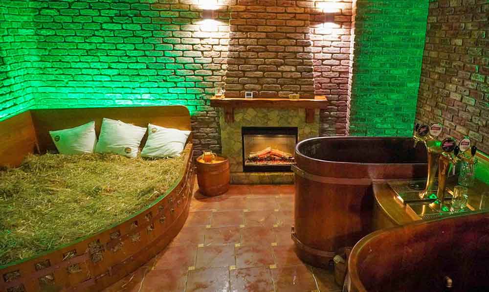  brick room with copper and wooden bath, straw bed and a fire at the beer spa. 