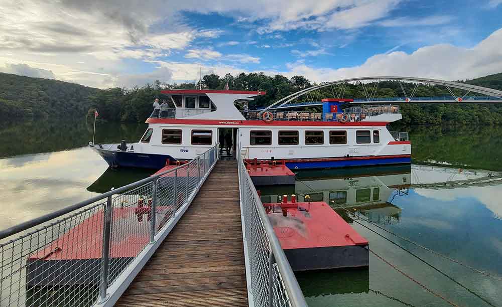 A boat at Viveri dock with tees in the background. 