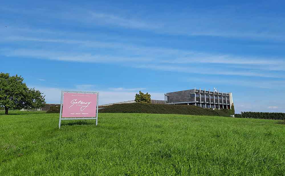 How To Visit 3 Vineyards Near Brno On An Easy Self-Guided Wine Tour, Czech Republic 8 Gotberg winery and fileds with the sign in the forground.