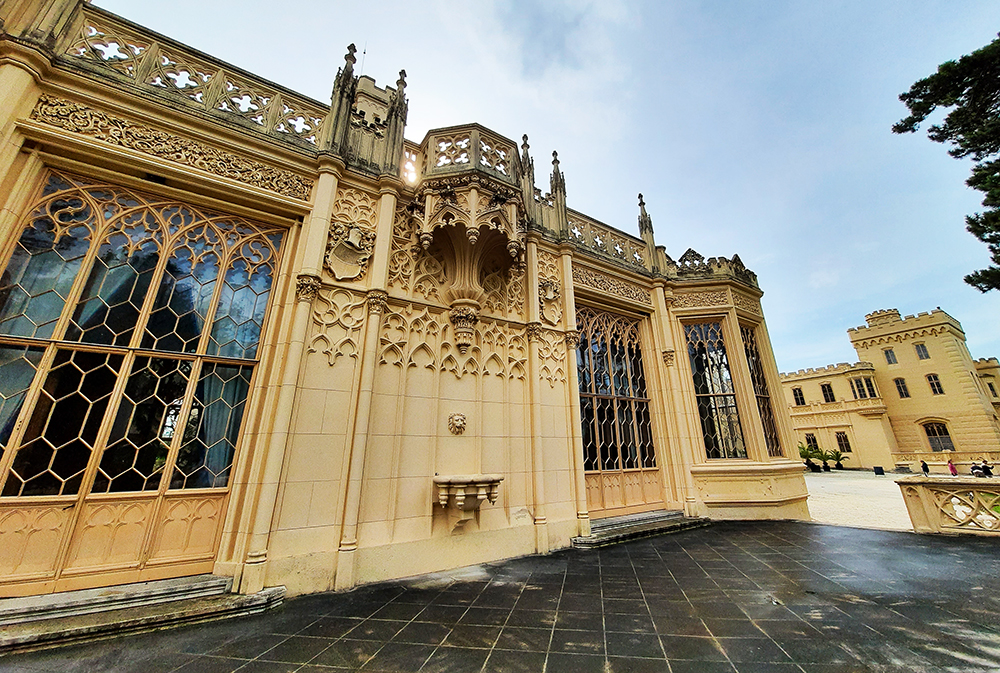 Outside Lednice castle with an ornate balcony and windows.