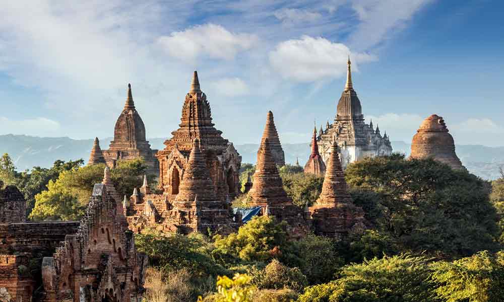 Bagan located in Myanmar featuring numerous pagodas and temples scattered across the landscape surrounded by lush trees