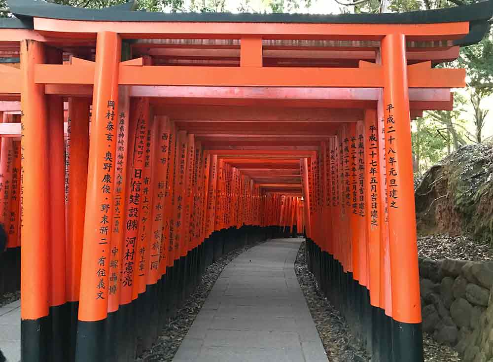 Fushimi-Inari Taisha Shrine in Japan features a thousands of vibrant red torii gates that form a mesmerizing tunnel-like