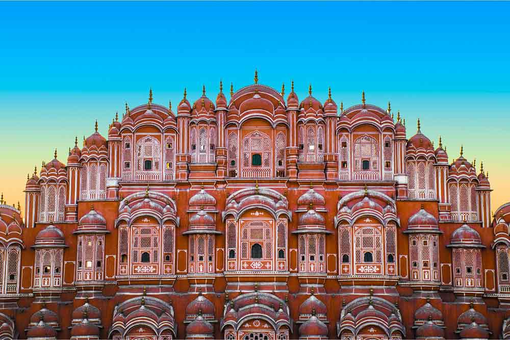 Hawa Mahal in India featuring a blush pink palace with intricately detailed windows and patterns
