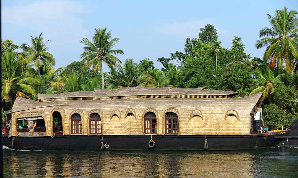 The Kerawala Backwaters in India with a black and gold large boat