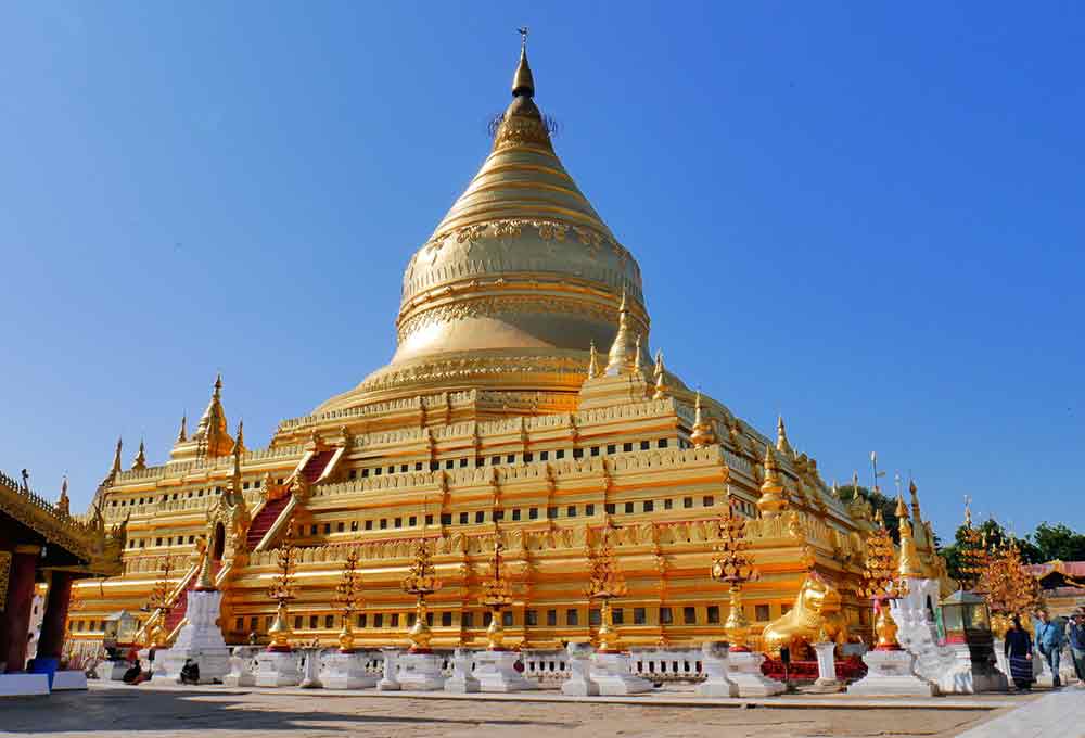 Shwezigon Pagoda - a Buddhist Temple in Myanmar featuring a large golden stupa that stand tall and glistens in the sunlight