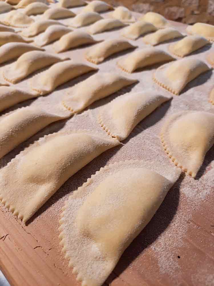 Cassatelle laid out ready to be cooked.