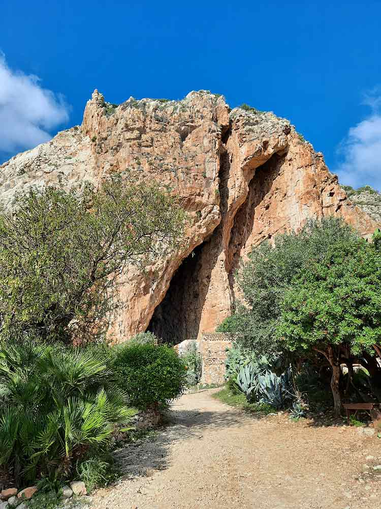 Outside the cave village of Grotta Mangiapane where you can see a gianlt cae in the rockside. 
