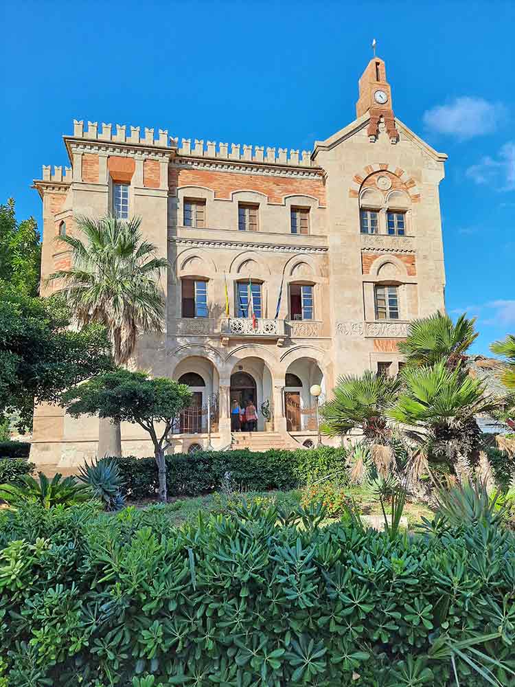 Peach coloured Florio family mansion surounded by trees and gardens