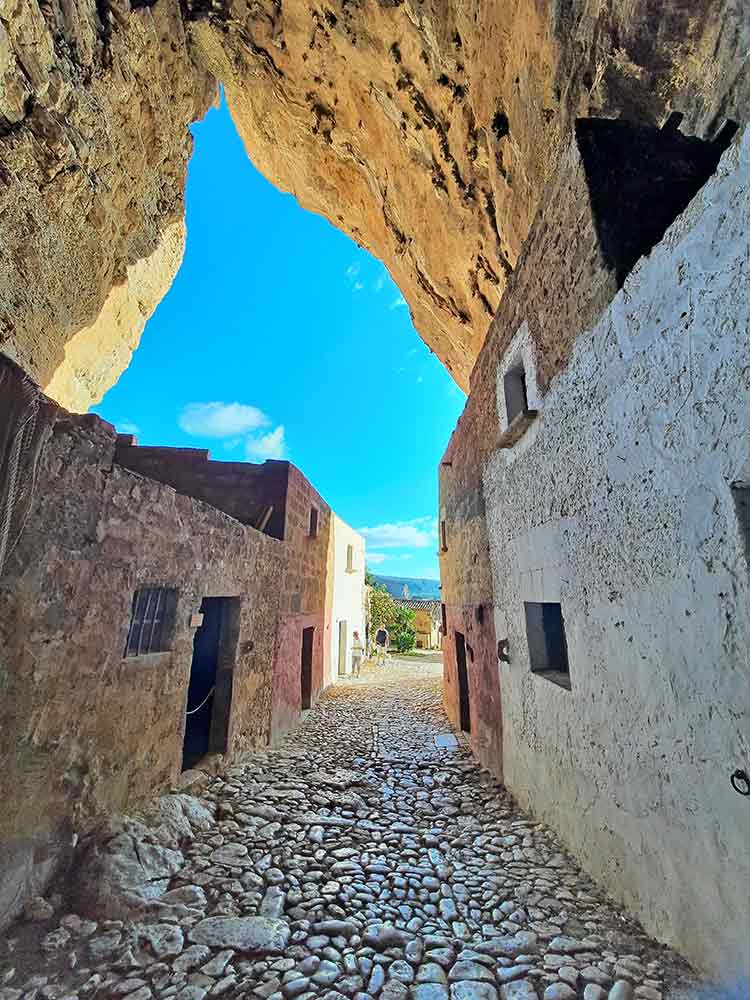 Inside the cave at Grotta Mangiapane. Rows of small buildings line each side of the cave, each building was a different shop. 