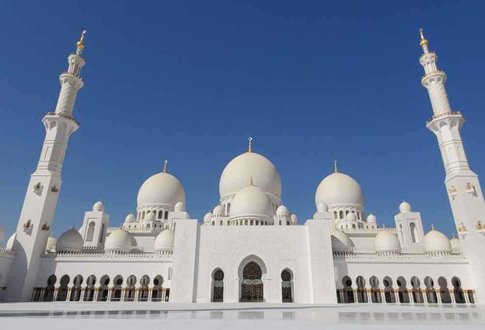 Sheikh Zayed Grand Mosque in Abu Dhabi, United Arab Emirates - one of the largest and beautiful mosques with its bright white marble exterior with multiple large and small domes at the top