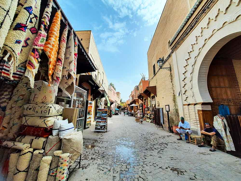 Various Souks of Marrakech selling rugs, cushions, clothing, and leather items.