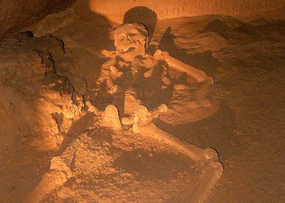 The Crystal Maiden - a skeleton lying on the sand found inside the cave