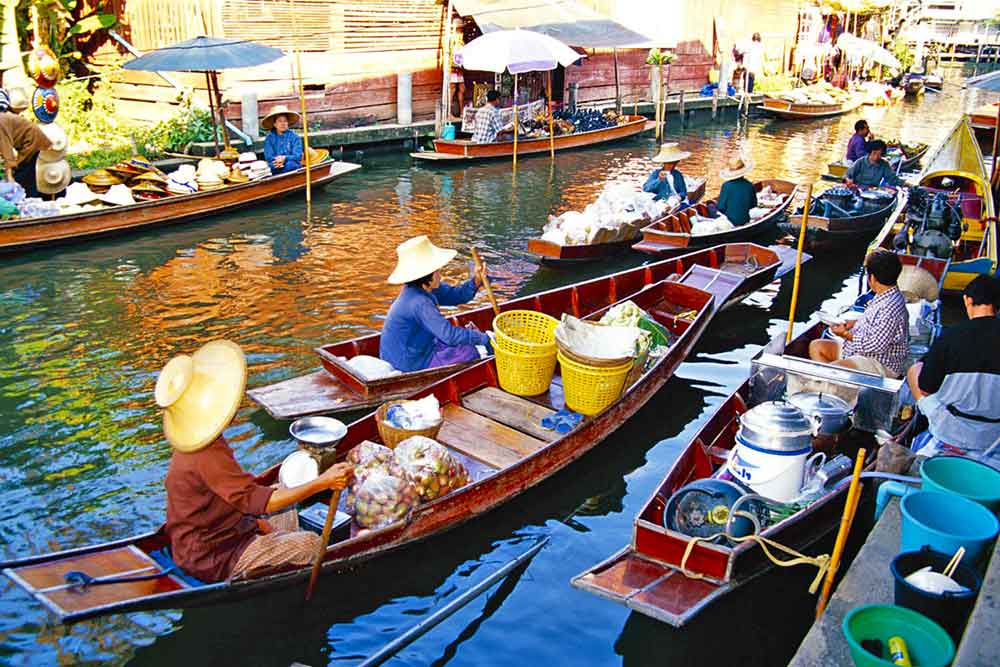 Is Bangkok Worth Visiting? 16 Great Reasons to Visit Bangkok 6 Using their boats, vendors sell their goods at Damnoen Floating Market