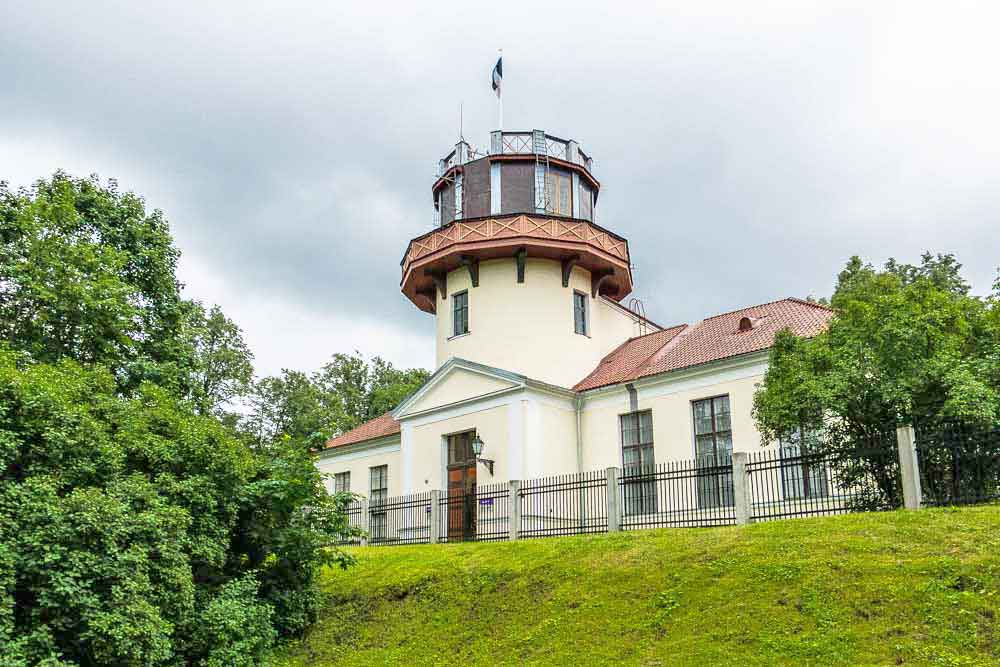 Best Of The Baltics: 23 Unmissable Things To Do In The Baltics 7 Tartu Observatory - a building with a red roof and a tower at the center, surrounded by greenery and a well-maintained lawn.