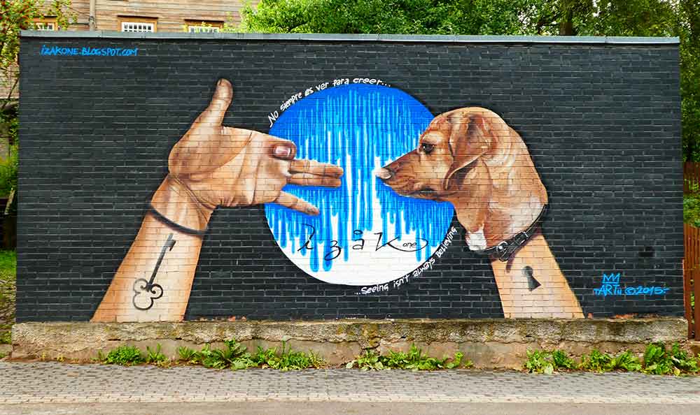 Best Of The Baltics: 23 Unmissable Things To Do In The Baltics 9 Tartu Street Art features a hand and a dog on a black-painted background.