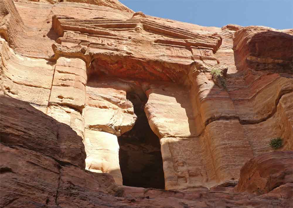 Best 2 Days in Petra Itinerary: Self-Guided Two Days in Petra, Jordan 13 The Lion Triclinium in Petra, Jordan, features a single entry adorned with two lion carvings at the entrance, basking in the gentle glow of sunlight.