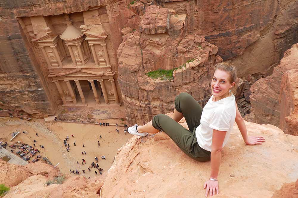 Best 2 Days in Petra Itinerary: Self-Guided Two Days in Petra, Jordan 1 Picture of me sitting on a rock overlooking the Treasury in Petra archaeological park as part of my 2 days in Petra self-guided tour.