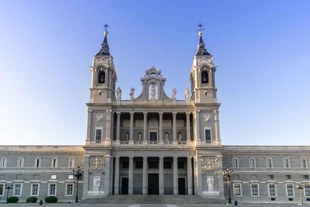 Almudena Cathedral glowing in the early light, one of Madrid’s standout sights for visitors discovering the city’s major landmarks.