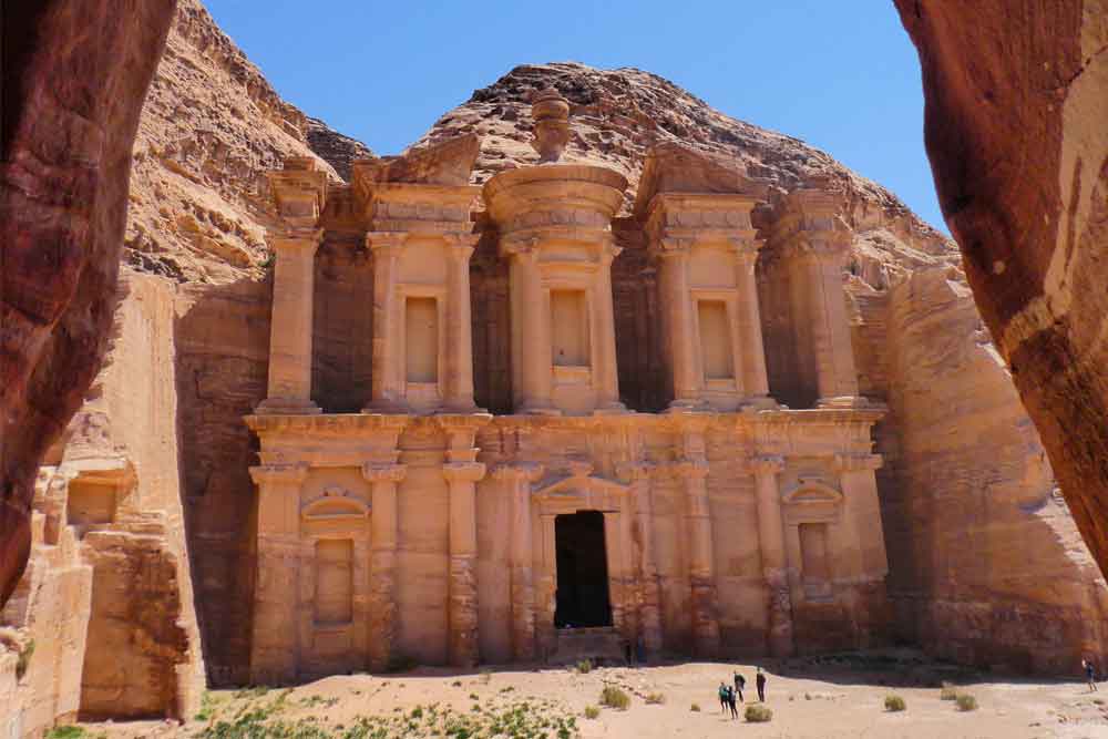 Best 2 Days in Petra Itinerary: Self-Guided Two Days in Petra, Jordan 14 The Monastery located in Petra, Jordan showcases a door pathway at the center with carved columns on a sand stone color