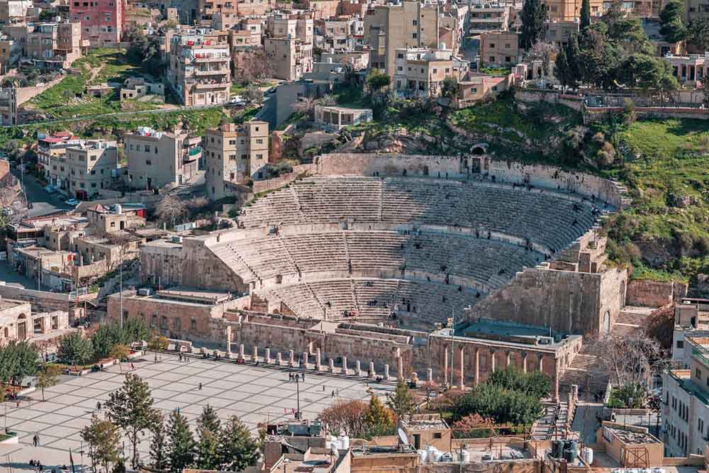 Roman amphitheater, an open-air theater with sandstone seating/staircase and a front wall serving as a magnificent venue for ancient entertainment and events.