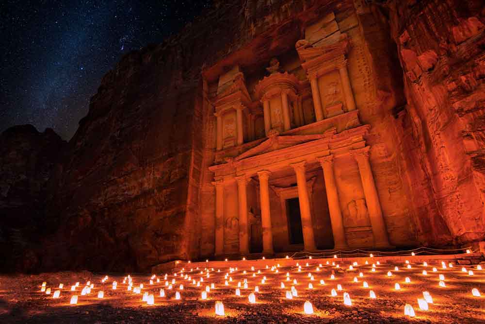 The Treasury at Petra is illuminated with glows at night, creating a mesmerizing and enchanting sight