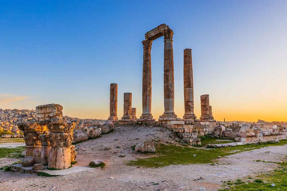 Ruins in Amman showcases tall columns during sunset