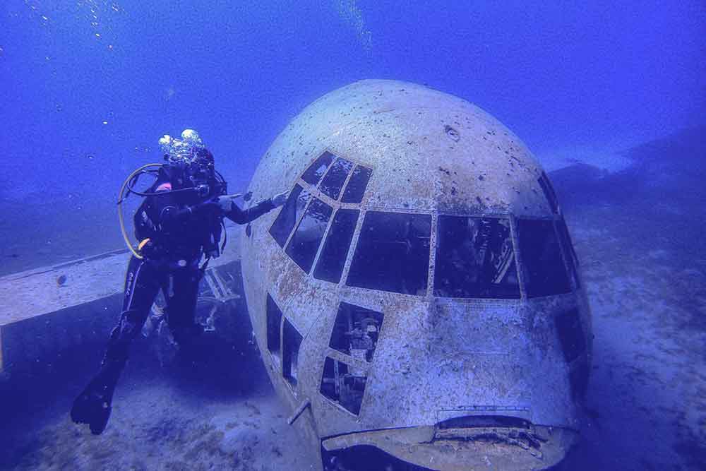 A sunken plane, Aqaba Dive, under the sea with a scuba diver