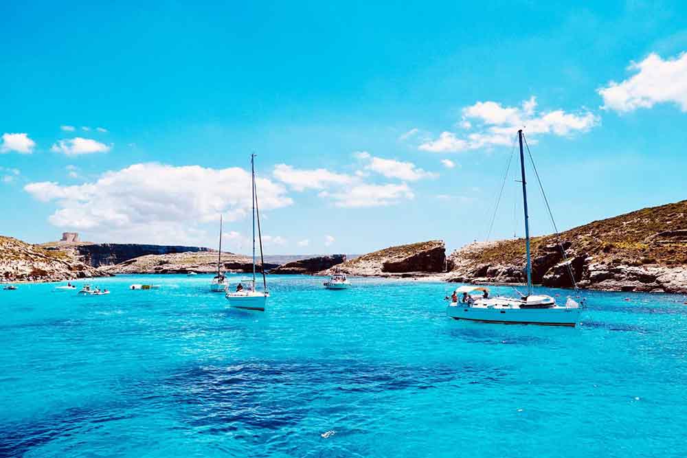 Boats are sailing in the middle of The Blue Lagoon on a sunny day