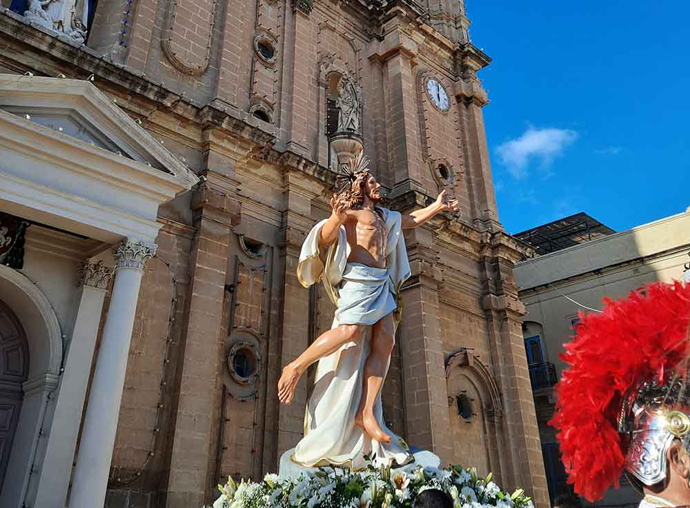 Easter Sunday Parade features a statue of Jesus in front of the church