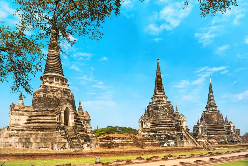 Is Bangkok Worth Visiting? 16 Great Reasons to Visit Bangkok 7 Ayutthaya Ruins with majestic tower-like structures that stand tall against in a blue sky