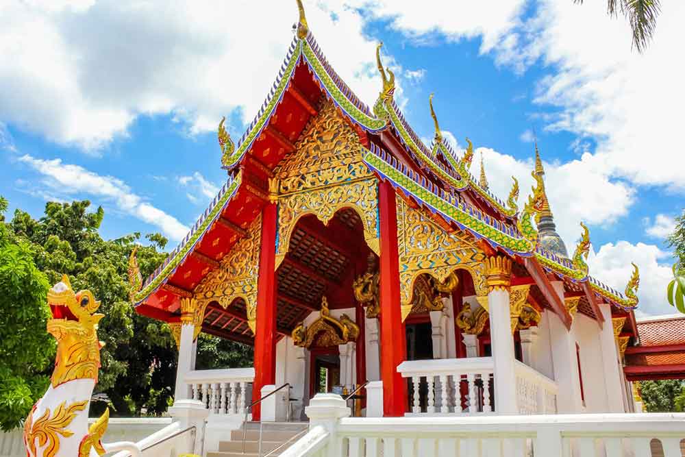 Vibrant colors in shades of red and gold adorn the temple in Chiang Mai