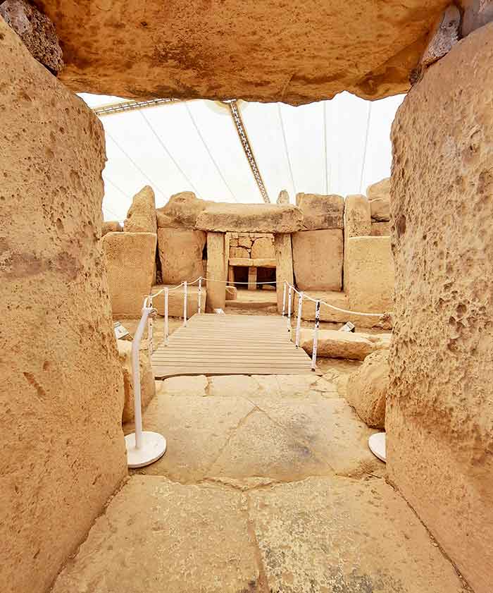 One Week in Malta: The Best 7 Days in Malta Itinerary 15 Hagar Qim and Mnajdra Ruins showcases the enormous stones with a hallway at the the middle