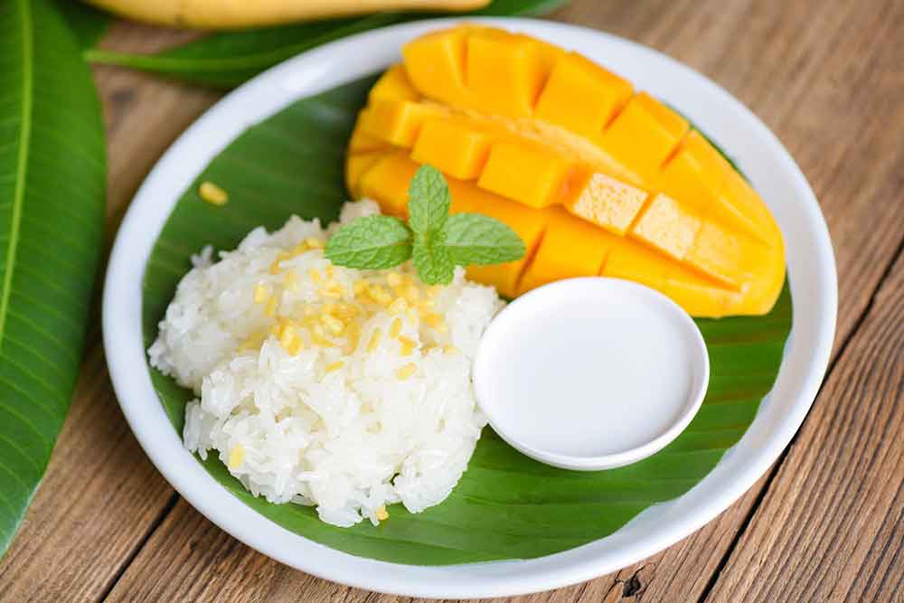 Is Bangkok Worth Visiting? 16 Great Reasons to Visit Bangkok 8 Mango sticky rice, a dessert with sticky rice, mango slices and coconut cream