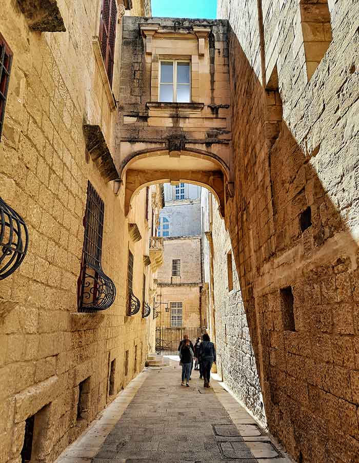 One Week in Malta: The Best 7 Days in Malta Itinerary 17 Narrow streets in Mdina featuring the brown brick wall and ironwork window