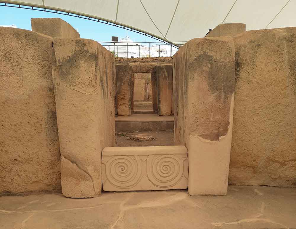 One Week in Malta: The Best 7 Days in Malta Itinerary 10 The Tarxien Ruins feature a large brown stone on each side with a twirl carving at the middle