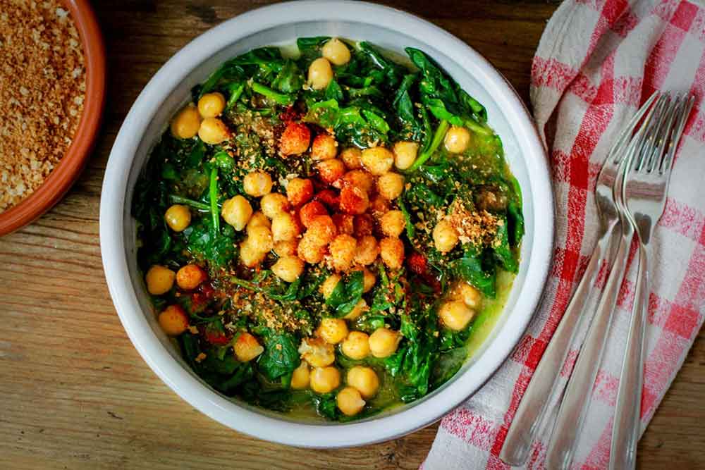 Espinacas y garbanzos in a bowl with sauteed spinach and chickpeas
