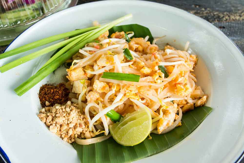 Pad Thai (Thai food) - A plate of rice noodles, tofu, peanuts and beans sprouts
