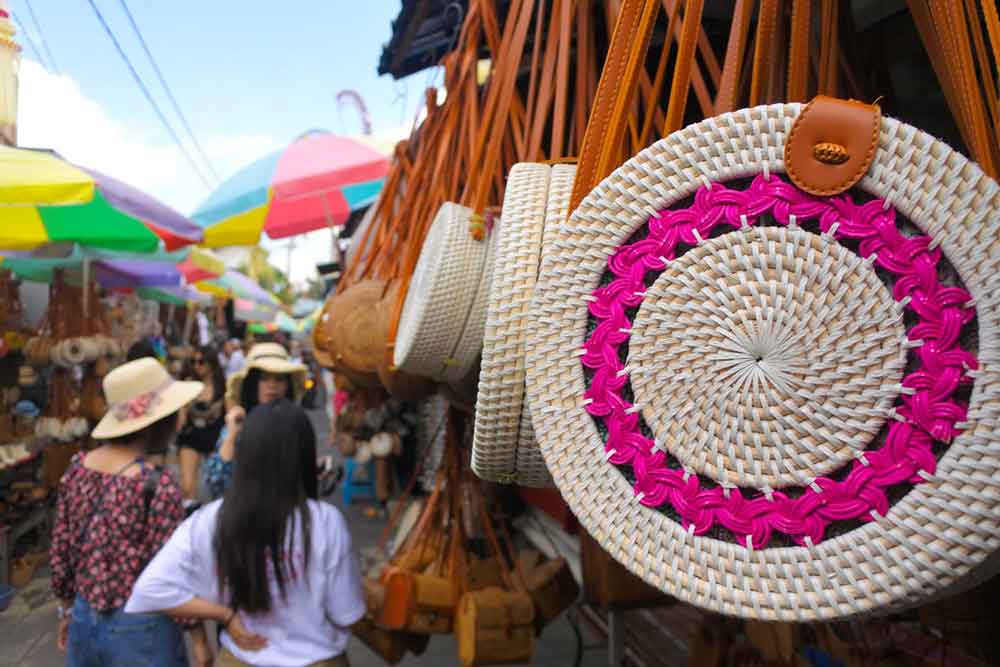 A rattan bag crafted from hand-woven bamboo displayed at Ubud Market