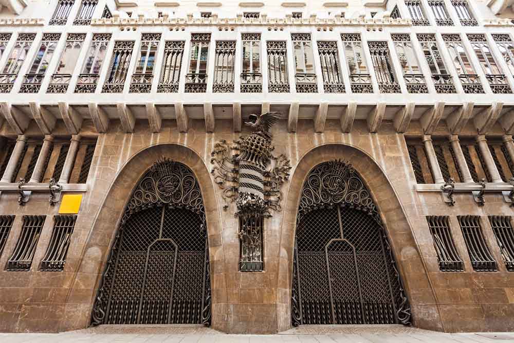 Barcelona Bucket List: 32 Best Things to Do in Barcelona, Spain 14 Palau Güell features unique dark-brown ironwork of doors and windows, with a dragon ironwork placed in the middle