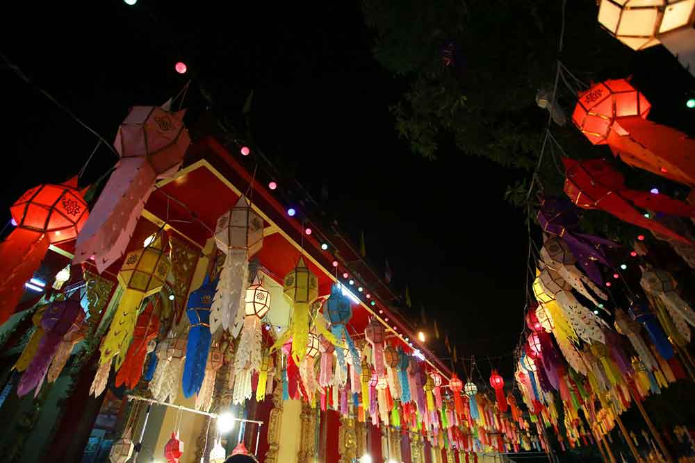 The vibrant Chiang Mai Night Bazaar comes alive at night, adorned with colorful lanterns