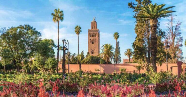 A minaret surrounded by colourful gardens in marrakech. This is the featured image for an article about the Best 2 Days in Marrakech Itinerary, Morocco